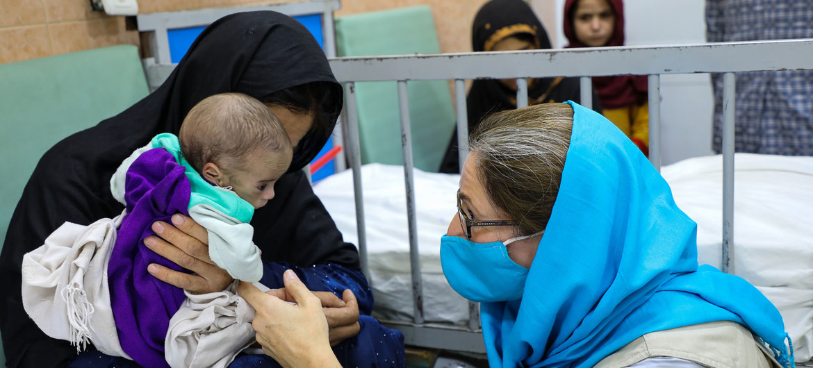 UNICEF Afghanistan's chief of communication, Sam Mort, interacts with a child at a malnutrition treatment ward at the Indira Gandhi Children's Hospital in Kabul..