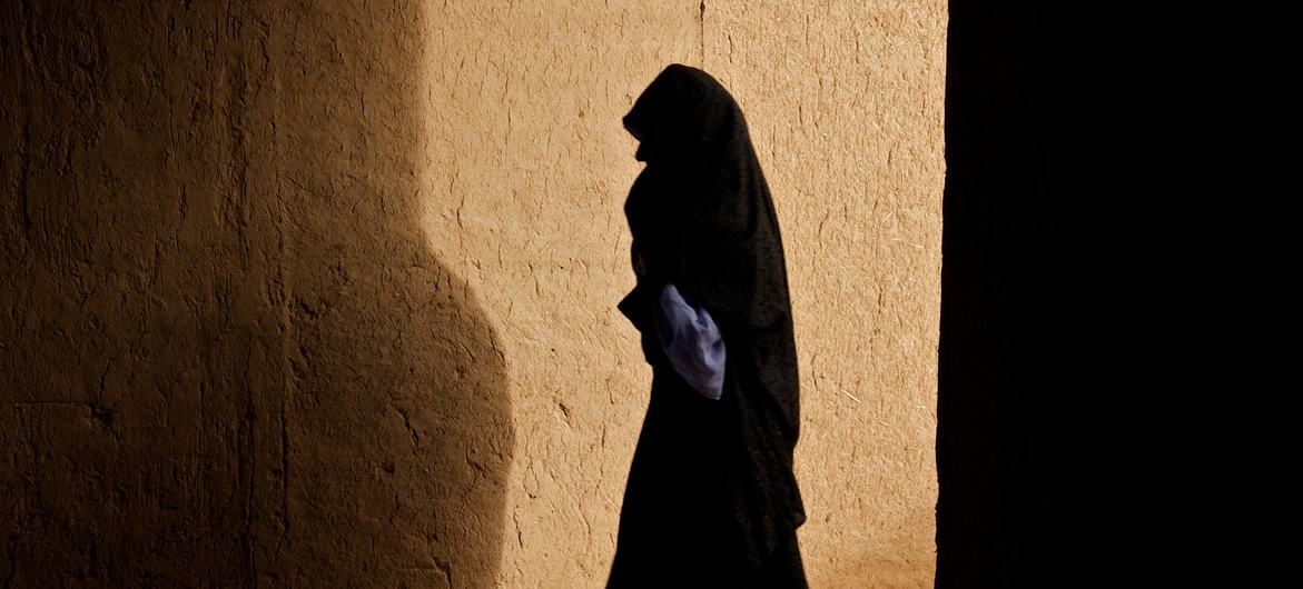 A woman walks through a corridor in a village in Zindajan district, Afghanistan. (File)